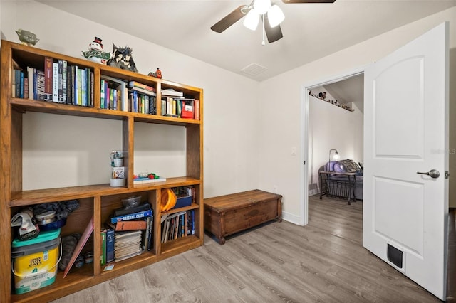 interior space with wood-type flooring and ceiling fan