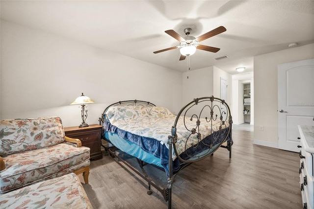 bedroom with hardwood / wood-style floors and ceiling fan