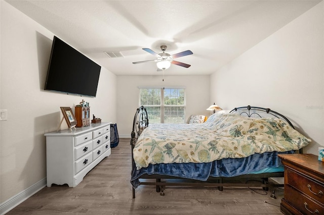 bedroom featuring ceiling fan and light hardwood / wood-style flooring