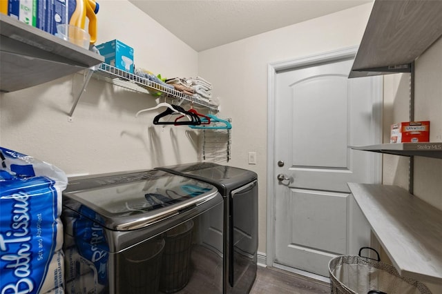 washroom featuring washing machine and clothes dryer and dark hardwood / wood-style floors