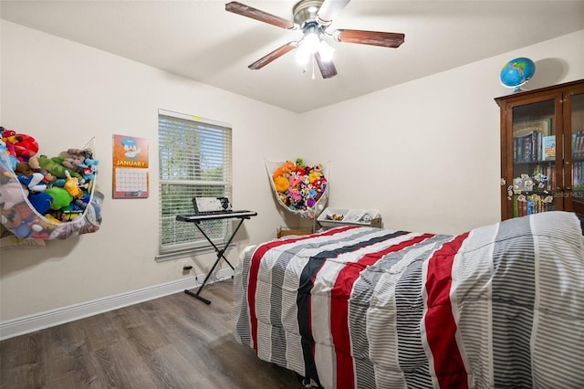 bedroom with dark hardwood / wood-style flooring and ceiling fan