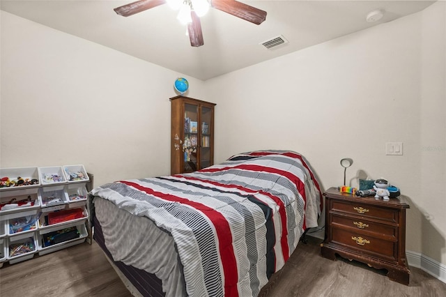 bedroom with ceiling fan and dark hardwood / wood-style flooring