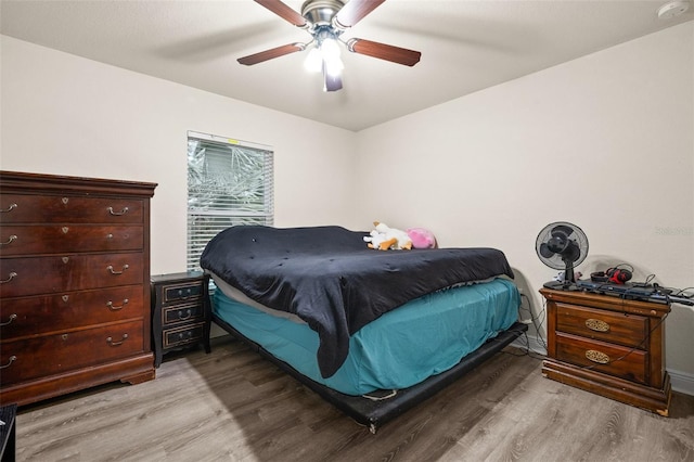 bedroom featuring ceiling fan and light hardwood / wood-style flooring