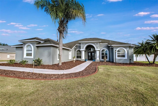 view of front of home with a front yard and french doors