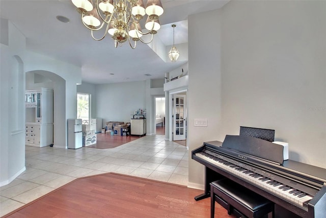 miscellaneous room featuring light tile patterned floors and a chandelier