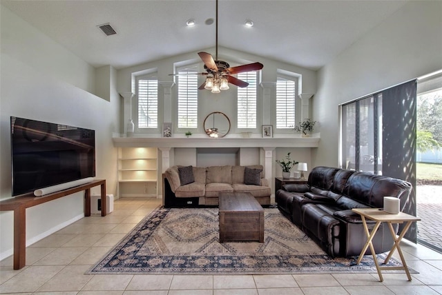 tiled living room featuring ceiling fan, a wealth of natural light, and lofted ceiling