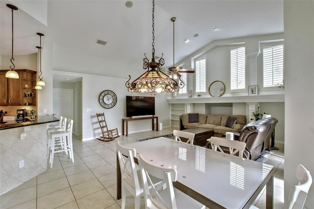 tiled dining room featuring lofted ceiling