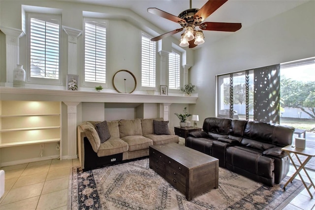 living room featuring ceiling fan, built in features, a healthy amount of sunlight, and light tile patterned flooring