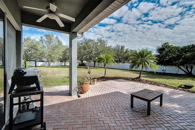 view of patio with ceiling fan and a grill