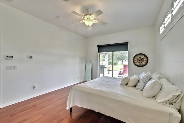 bedroom featuring ceiling fan, dark hardwood / wood-style flooring, and access to outside