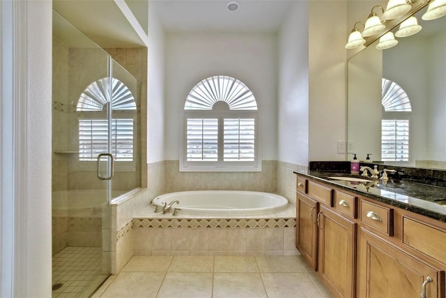 bathroom with tile patterned flooring, vanity, and shower with separate bathtub