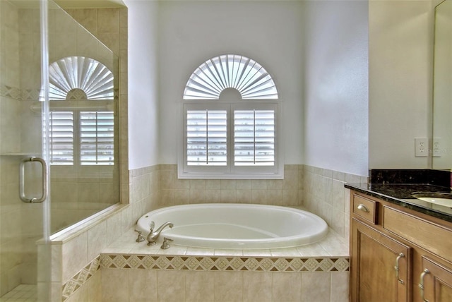 bathroom with vanity and independent shower and bath