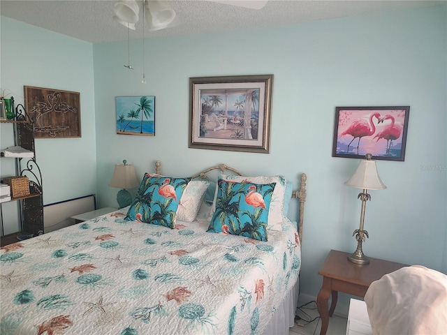 bedroom with a textured ceiling and ceiling fan