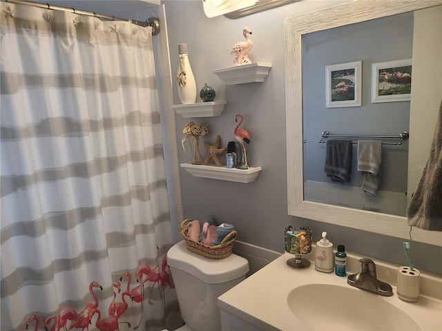 bathroom featuring toilet and vanity