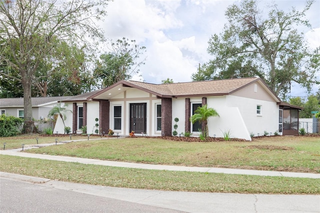 single story home featuring a front lawn