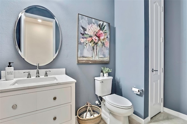 bathroom with vanity, tile patterned floors, and toilet