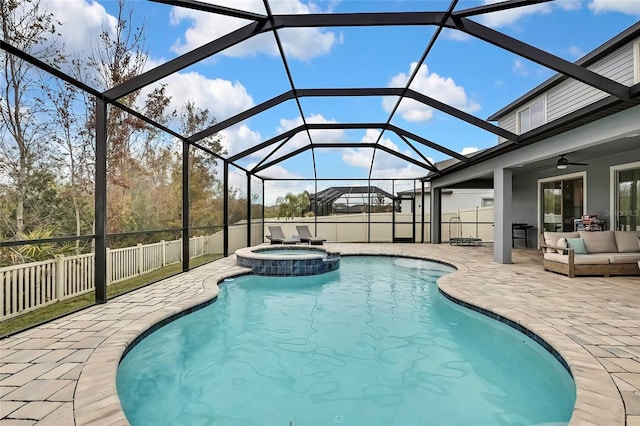 view of pool featuring an in ground hot tub, ceiling fan, glass enclosure, outdoor lounge area, and a patio area