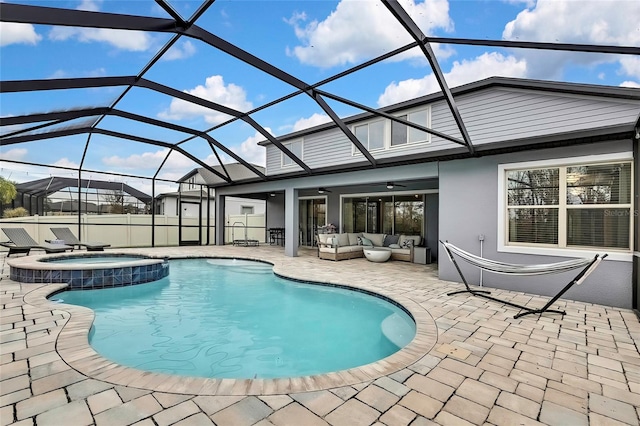 view of swimming pool with an outdoor hangout area, a patio, glass enclosure, ceiling fan, and an in ground hot tub