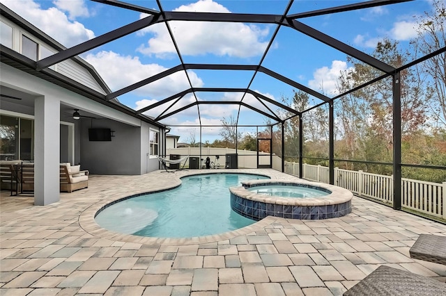 view of swimming pool with an in ground hot tub, ceiling fan, a lanai, a patio, and outdoor lounge area