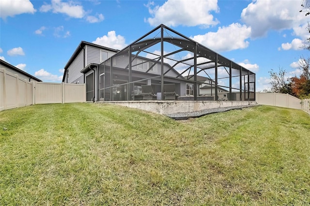 back of house featuring a yard and glass enclosure