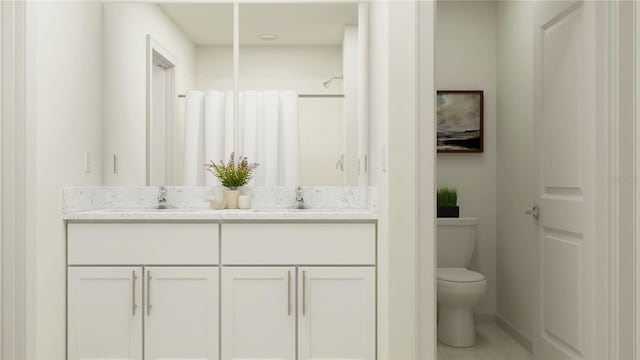 bathroom with curtained shower, vanity, and toilet