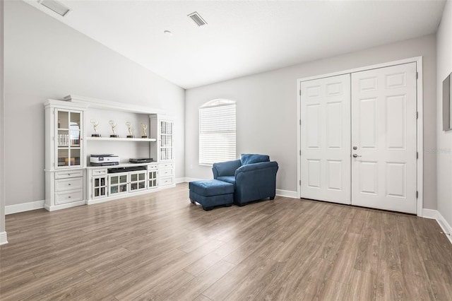 sitting room with lofted ceiling and hardwood / wood-style flooring