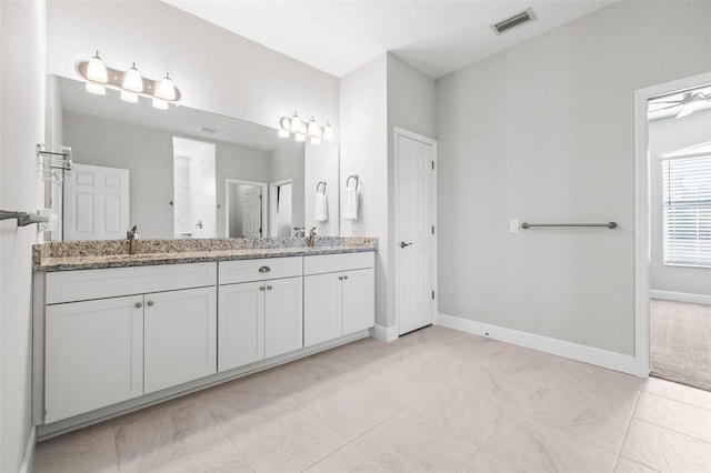 bathroom with ceiling fan, tile patterned floors, and vanity