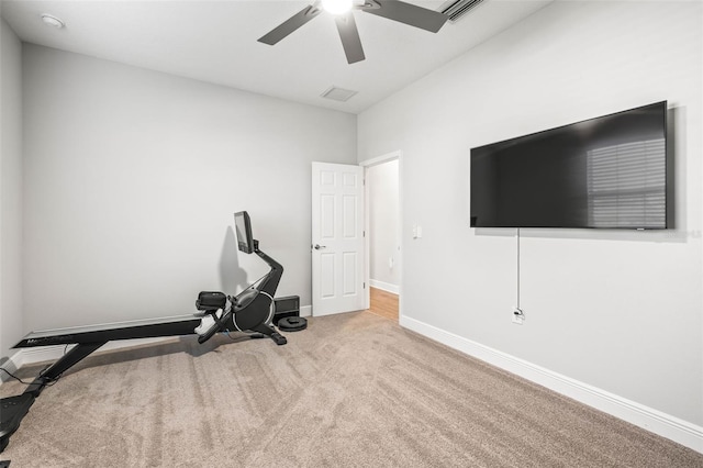 exercise area featuring ceiling fan and light carpet