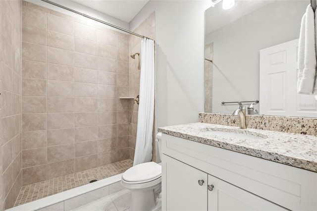 bathroom featuring toilet, vanity, tile patterned flooring, and walk in shower