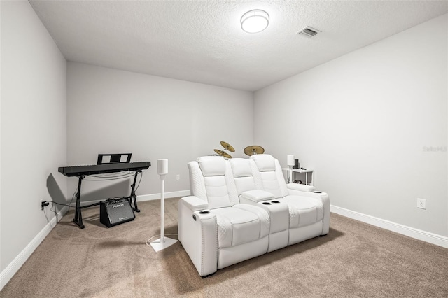 carpeted home theater room with a textured ceiling