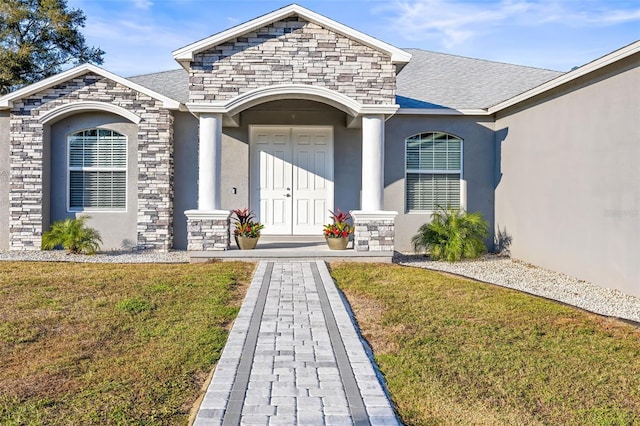 property entrance with a lawn