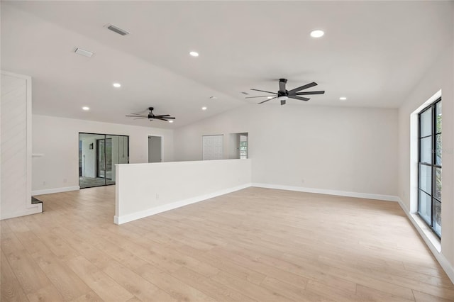 spare room with light wood-type flooring, ceiling fan, and vaulted ceiling