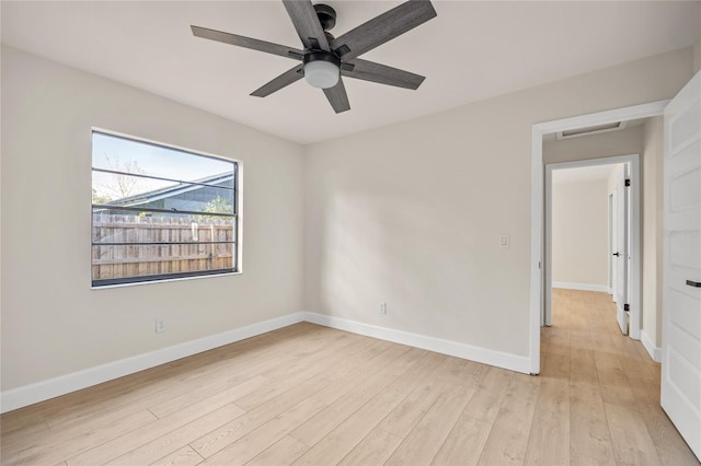 empty room with ceiling fan and light hardwood / wood-style floors