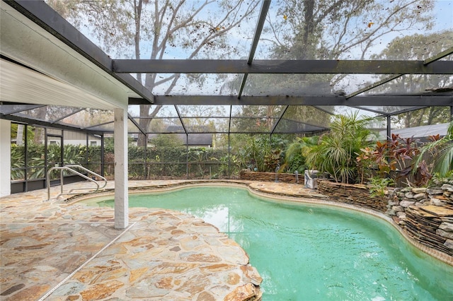 view of swimming pool with a lanai and a patio area