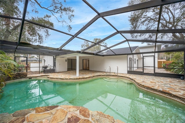 view of swimming pool with a patio area and glass enclosure