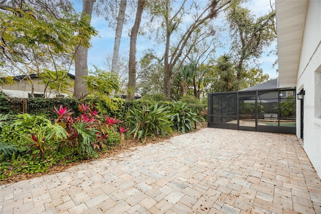 view of patio featuring a lanai