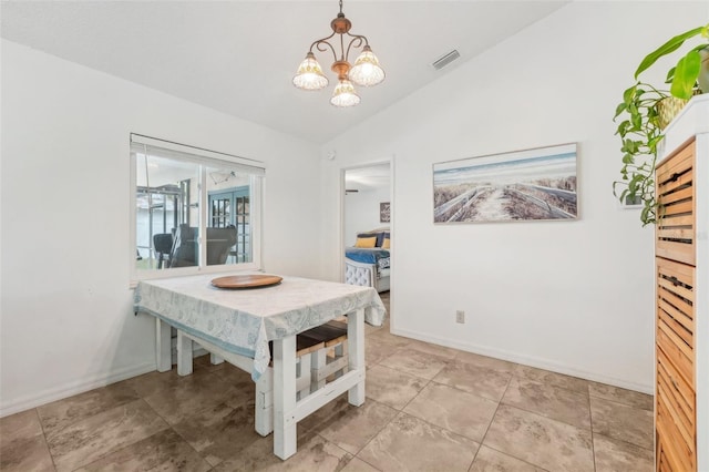 dining space with an inviting chandelier and vaulted ceiling