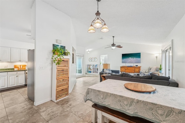 dining area featuring ceiling fan and vaulted ceiling