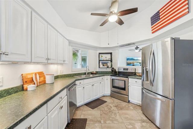 kitchen featuring sink, white cabinets, light tile patterned flooring, and appliances with stainless steel finishes