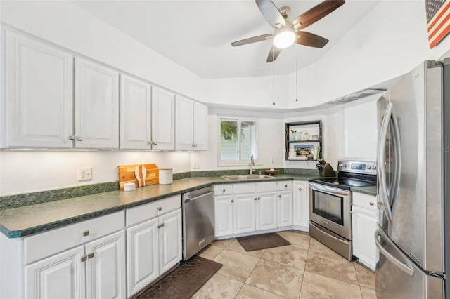 kitchen featuring stainless steel appliances, sink, white cabinets, lofted ceiling, and ceiling fan