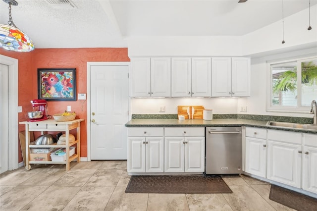 kitchen featuring a textured ceiling, sink, white cabinetry, decorative light fixtures, and stainless steel dishwasher