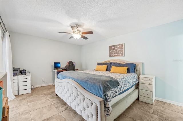 tiled bedroom with ceiling fan and a textured ceiling