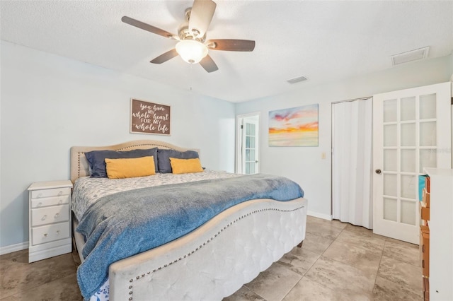 bedroom with ceiling fan, a closet, and a textured ceiling