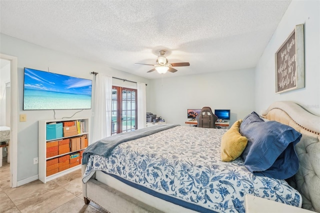 bedroom featuring ceiling fan, a textured ceiling, and light tile patterned floors