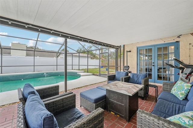 exterior space featuring a patio, french doors, glass enclosure, and an outdoor living space