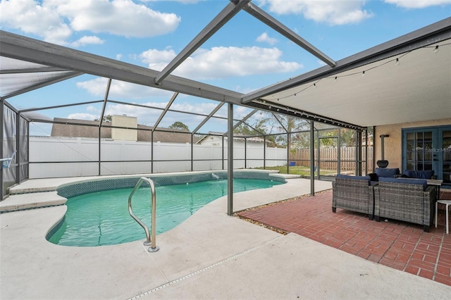 view of pool featuring glass enclosure, outdoor lounge area, and a patio