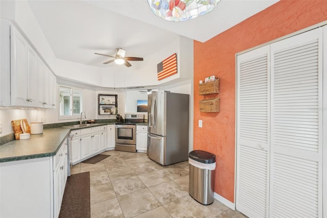 kitchen featuring stainless steel appliances, white cabinetry, sink, and ceiling fan