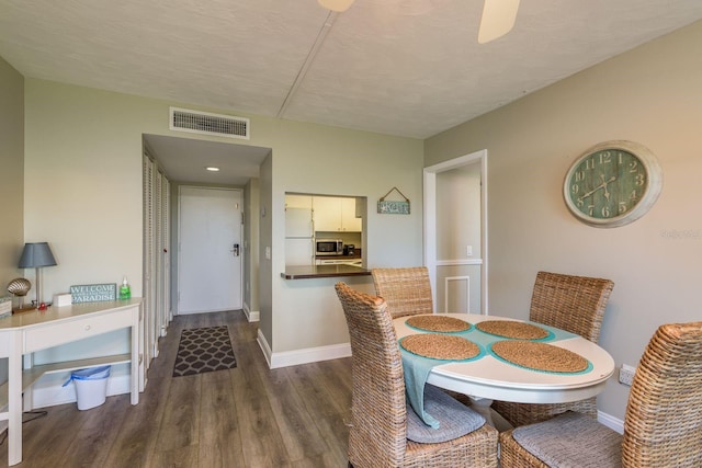 19451 Gulf Blvd Unit 204, Indian Shores, FL 33785 - dining space featuring dark wood finished floors, baseboards, ceiling fan, and visible vents