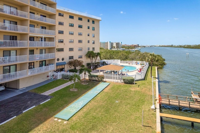 19451 Gulf Blvd Unit 204, Indian Shores, FL 33785 - exterior space featuring a pool, a water view, a yard, and shuffleboard