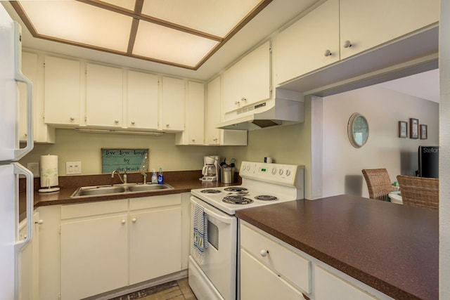 19451 Gulf Blvd Unit 204, Indian Shores, FL 33785 - kitchen with dark countertops, a sink, under cabinet range hood, and white appliances
